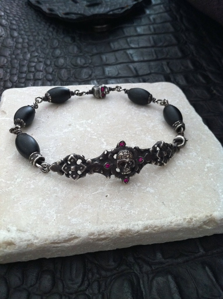 Sterling Silver Dark Antiqued Two Skull Bar Diamond & Ruby Pave Bracelet with Oval Onyx Beads