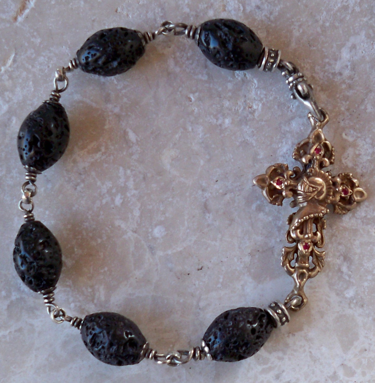 Bronze cross with rubies and black lava beads