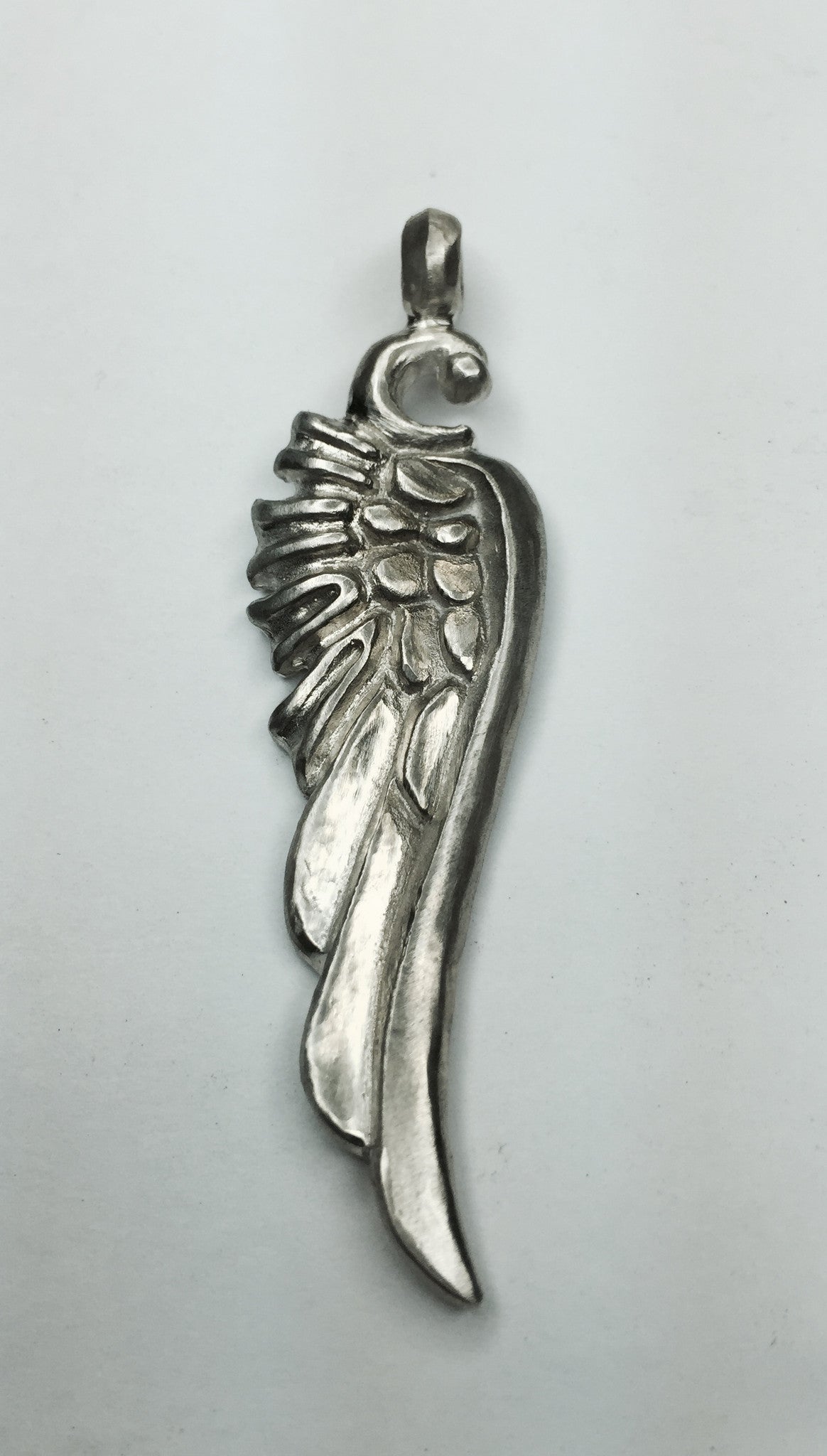 Sterling silver wing pendant hand carved