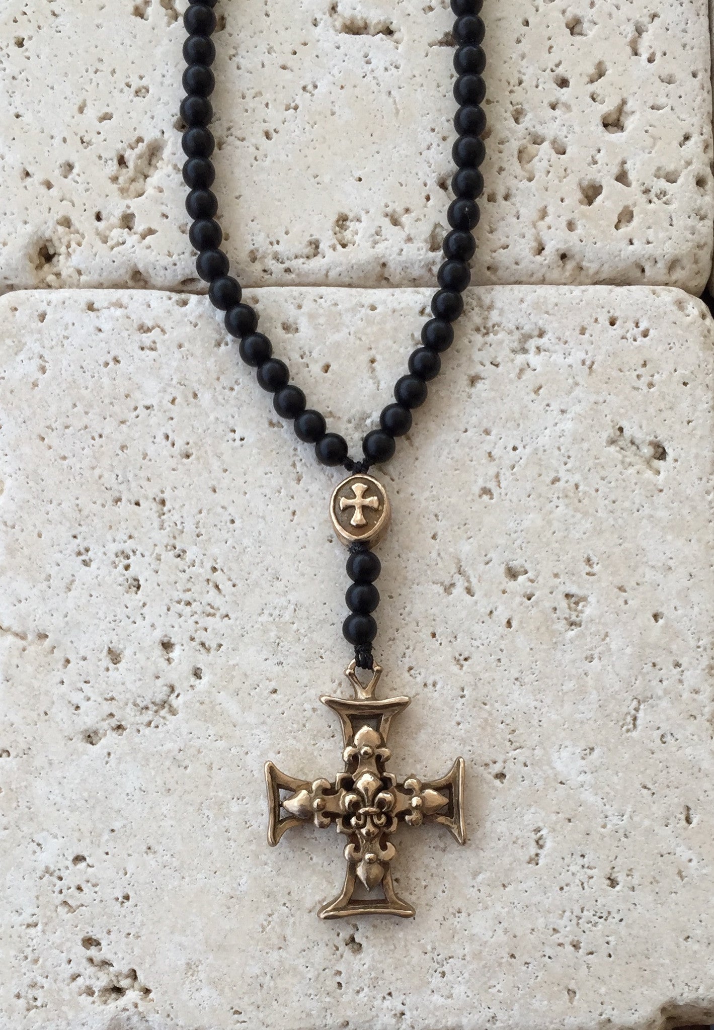 Bronze cross with fleur de lis center and onyx beads